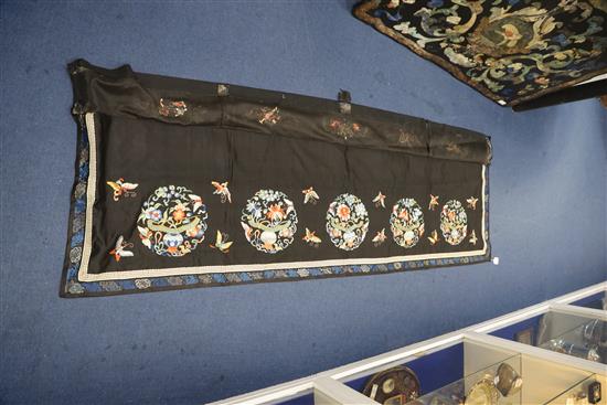 A Chinese embroidered black satin table frontal, late Qing dynasty, 211 x 56cm